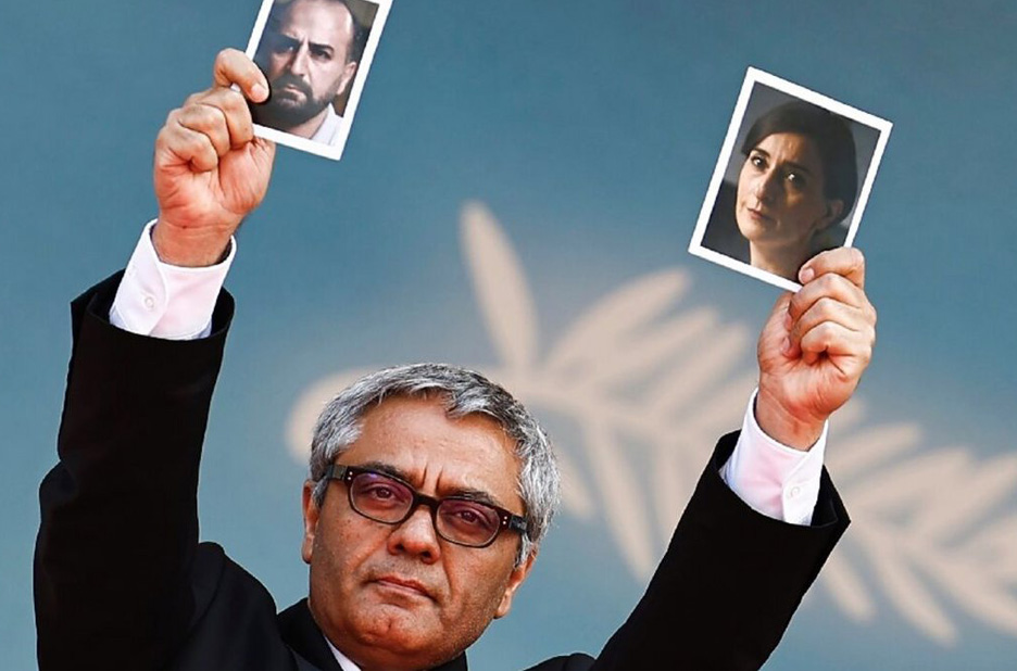 Rasoulof holds portraits of Misagh Zare and Soheila Golestani, stars of The Seed of the Sacred Fig, who were unable to leave Iran for the première at Cannes.